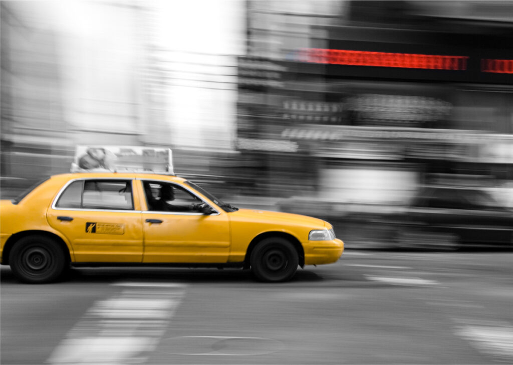 yellow taxi cab driving cross city